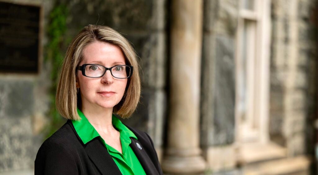 headshot of Lisa Belokur wearing a green shirt and black jacket